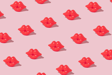 Creative pattern made with bright red lips figurine on pastel pink background. Romantic retro style idea. Valentines day concept