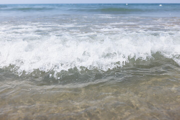 Closeup of sea wave with white foam background