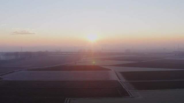 Aerial view Beautiful rice valley during sunset, rice fields in Vercelli. Beautiful and surreal landscape. Flying over a cinematic rural and characteristic scape during golden hour. 