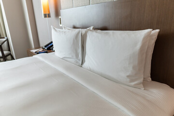 Fototapeta na wymiar Comfort luxury modern hotel Bedroom interior the morning with white bed and pillow