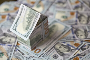 a house of money on the background of money, dollar bills the concept of accumulating investing money