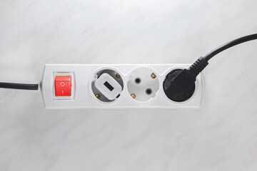 Inflamed plug in power board - result of electrical short circuit, selective focus