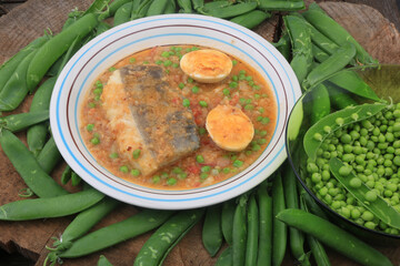 cod with green peas and egg as sea food with vegetables healthy eating