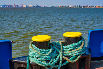 View over two bollards on a ferry to the skyline of Bremerhaven / Germany