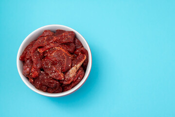 marinated raw meat with spices in red and white bowl