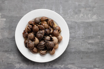 boiled snails on white small plate