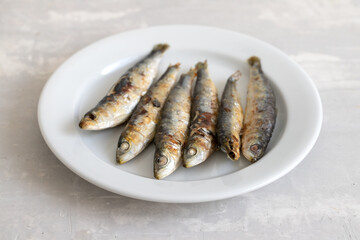 fried sardines on white small dish