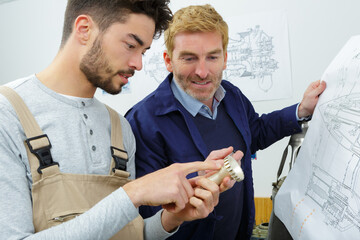 worker and architect watching some details on a construction