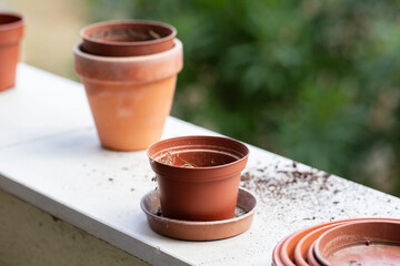 empty adn with ground ceramic and plastic pots on balcony