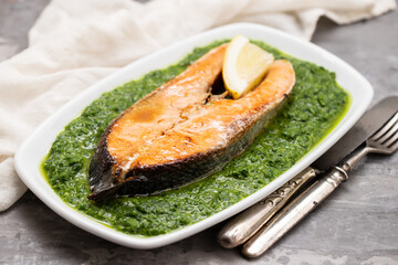 fried salmon with fresh lemon and spinach