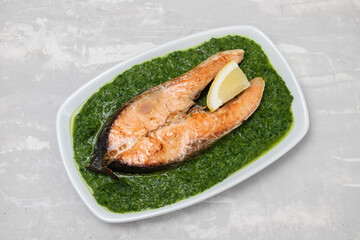 fried salmon with fresh lemon and spinach