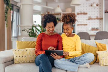 Mother and daughter downloading music.