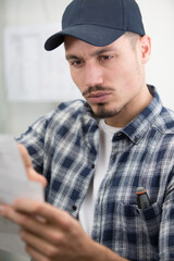 male worker reading instruction