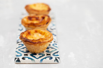 typical portugese egg tart pastel de nata on ceramic background
