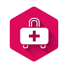 White First aid kit icon isolated with long shadow background. Medical box with cross. Medical equipment for emergency. Healthcare concept. Pink hexagon button. Vector