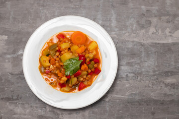 lentil with pepper, courgette and onion on white dish