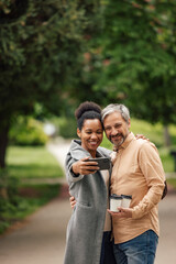 Fototapeta premium Adult African woman, taking a picture with her husband.