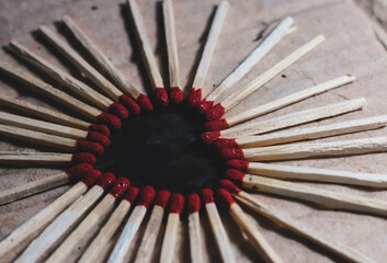Matchstick with a red heart-shaped head on a wooden background. Matchstick art photography. 