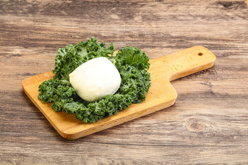 Soft mozzarella cheese over board