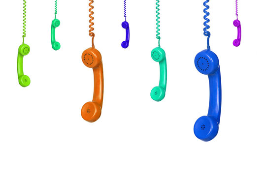 Many colorful vintage phones hanging