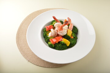 stir fried green broccoli with fresh big tiger prawn and bell pepper in oyster sauce in white plate asian halal menu