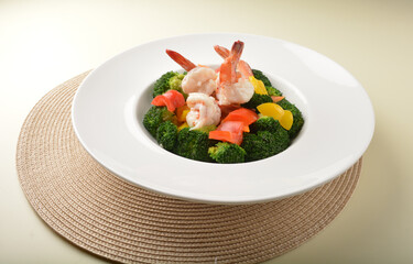 stir fried green broccoli with fresh big tiger prawn and bell pepper in oyster sauce in white plate asian halal menu