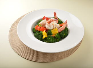 stir fried green broccoli with fresh big tiger prawn and bell pepper in oyster sauce in plate on wood table chinese restaurant asian cafe vegan halal menu