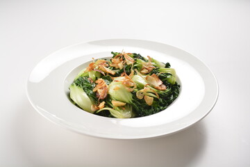 stir fried vegetable nai bai with garlic and mushroom in oyster sauce in white plate asian halal menu
