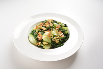 stir fried vegetable nai bai with garlic and mushroom in oyster sauce in white plate asian halal menu