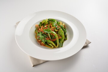 stir fried kai lan vegetable with spicy chilli sambal sauce in white plate asian halal menu