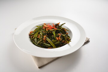 stir fried kang kong vegetable with spicy sambal chilli sauce in white plate asian halal menu