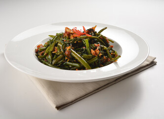 stir fried kang kong vegetable with spicy sambal chilli sauce in white plate asian halal menu
