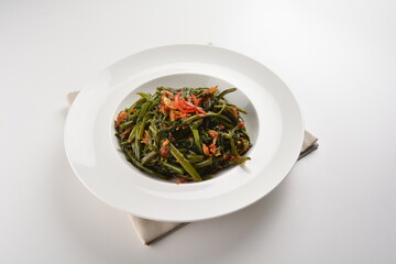 stir fried kang kong vegetable with spicy sambal chilli sauce in white plate asian halal menu
