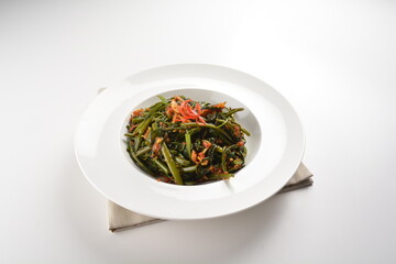 stir fried kang kong vegetable with spicy sambal chilli sauce in white plate asian halal menu