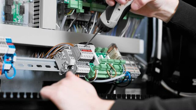 Electric hand hands installing electric component circuitboard motherboard drilling drill tool tools person contract contractor working work job professional nerdy handy man handyman power outlet wire