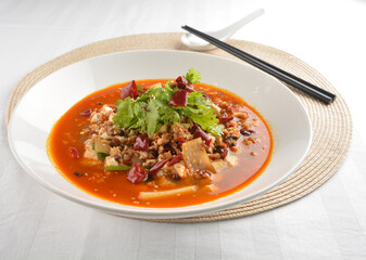 stir fried mapo tofu bean curd in spicy mala chilli sauce in white plate asian halal menu