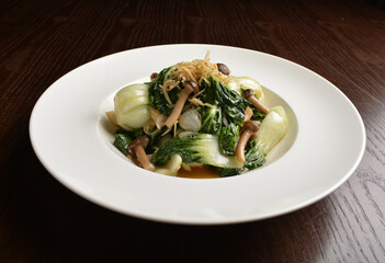 stir fried vegetable nai bai with garlic and mushroom in oyster sauce in white plate asian halal menu