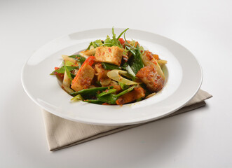 stir fried vegetable with bean curd tofu in spicy sambal chilli sauce in white plate asian halal menu