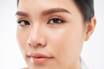 Fototapeta premium Face of attractive young woman looking at camera with flawless foundation on her skin