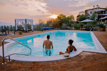 Luxury country house with swimming pool in Italy. Pool and old farmhouse during sunset central...