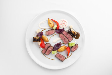 Grilled sliced roast beef with pepper, eggplant and potato isolated on white background