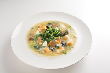 stir fried water spinach vegetable with trio eggs in thick gravy sauce in white plate asian halal menu