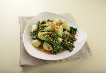 stir fried vegetable nai bai with garlic and mushroom in oyster sauce in white plate asian halal menu