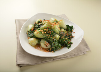 stir fried vegetable nai bai with garlic and mushroom in oyster sauce in white plate asian halal menu