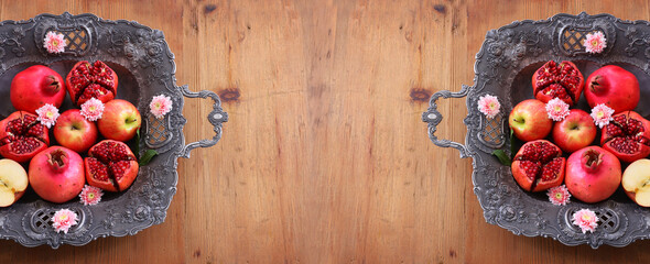 Rosh hashanah (jewish New Year holiday) concept. Pomegranate and apple raditional symbols