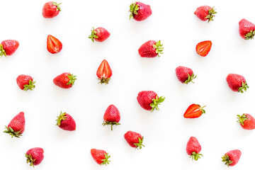 Group of ripe strawberries with green leaves. Flat lay