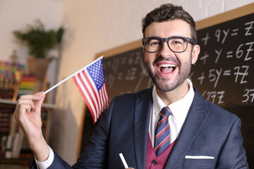 Elegant teacher holding the USA flag