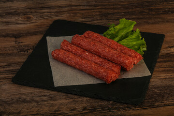 Raw beef sausages with spices