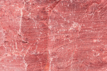 Texture of rough torn edge of slightly layered red stone