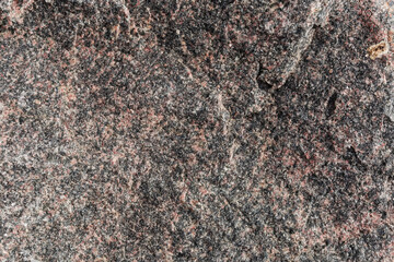 Texture of rough torn edge of the black-red stone